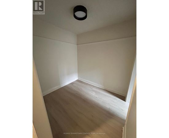 A room with a wooden floor and white walls.