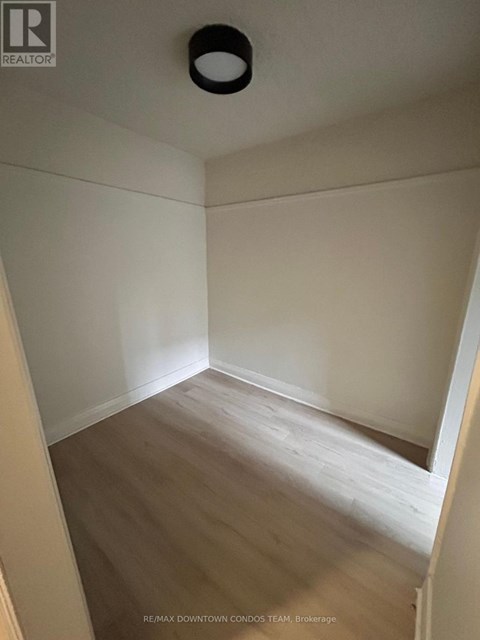 A room with a wooden floor and white walls.