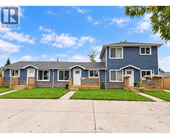 A blue house with a white door and windows is for sale.