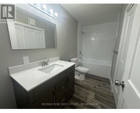 A bathroom with a sink, toilet, and bathtub.
