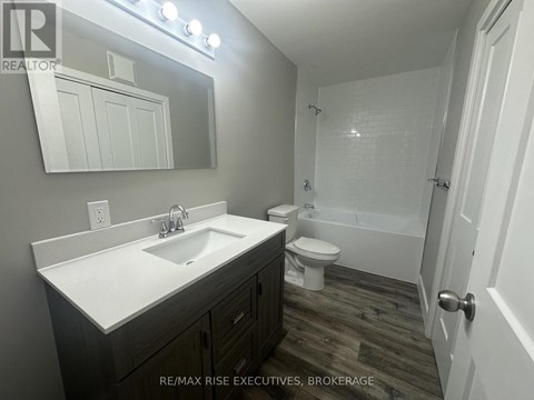A bathroom with a sink, toilet, and bathtub.