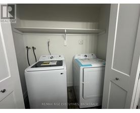A small laundry room with a washer and dryer.