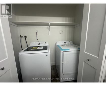 A small laundry room with a washer and dryer.