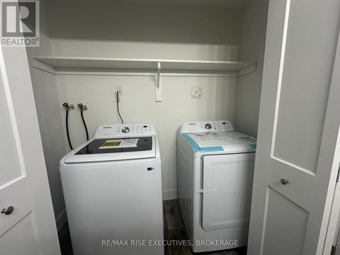 A small laundry room with a washer and dryer.