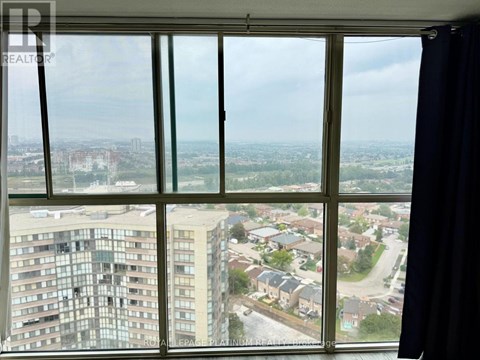 A view from a window looking out at a cityscape.
