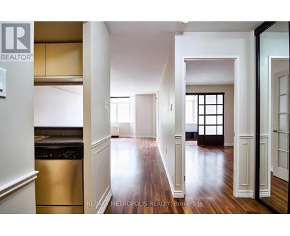 A spacious kitchen with white cabinets and a stainless steel dishwasher.