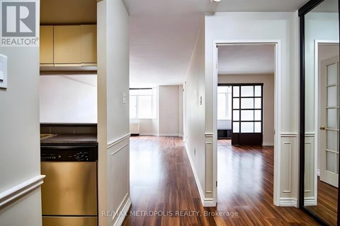 A spacious kitchen with white cabinets and a stainless steel dishwasher.