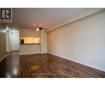 A room with wooden flooring and a ceiling fan.