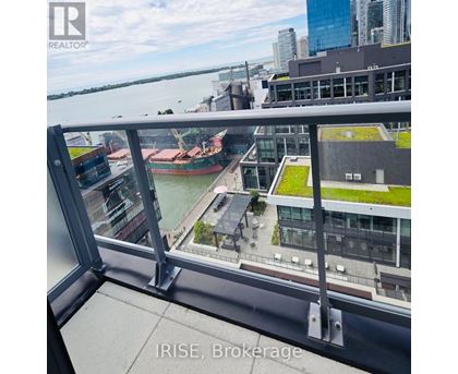 A view from a high-rise building looking down at a river and a barge.