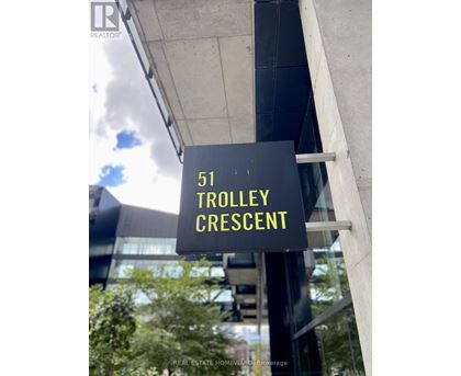 A sign that says Trolley Crescent in yellow on a black background.