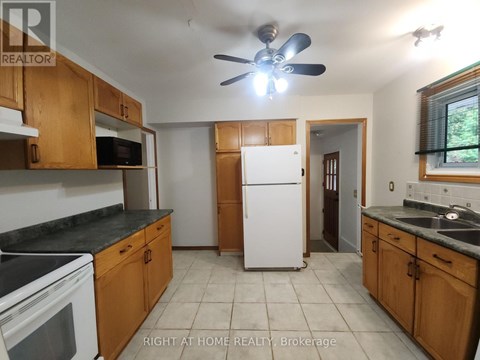 A kitchen with wooden cabinets and a white refrigerator.