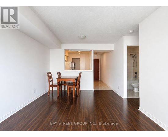 A dining room with a table and chairs in the middle of the room.