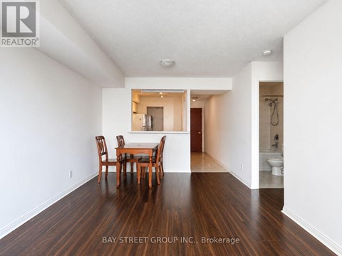 A dining room with a table and chairs in the middle of the room.