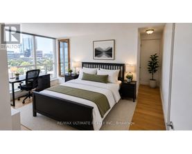 A bedroom with a large bed and a desk with a chair.