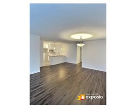 A room with wooden floors and white walls.
