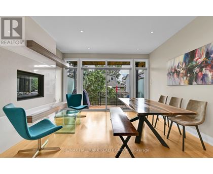 A modern dining room with a long table and chairs.