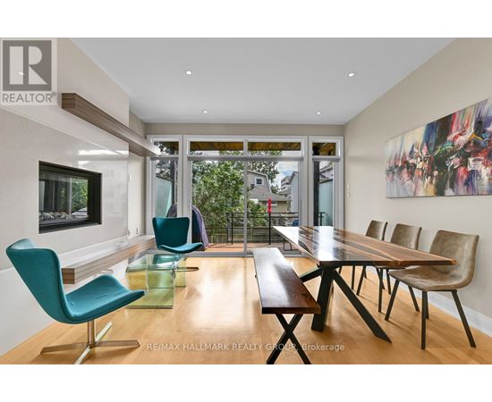 A modern dining room with a long table and chairs.