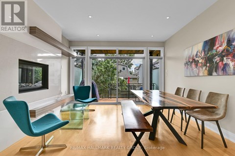 A modern dining room with a long table and chairs.