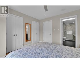 A bedroom with a large bed and a mirror on the wall.