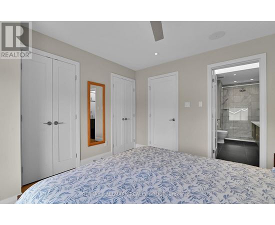 A bedroom with a large bed and a mirror on the wall.