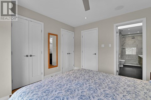 A bedroom with a large bed and a mirror on the wall.