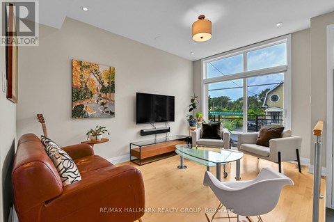 A living room with a brown leather couch and a glass coffee table.
