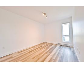 A room with wooden flooring and a window.