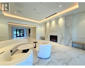 A white marble room with a fireplace and a bench.