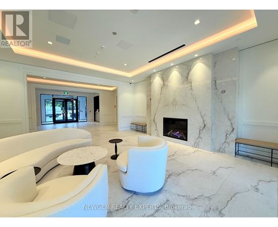 A white marble room with a fireplace and a bench.