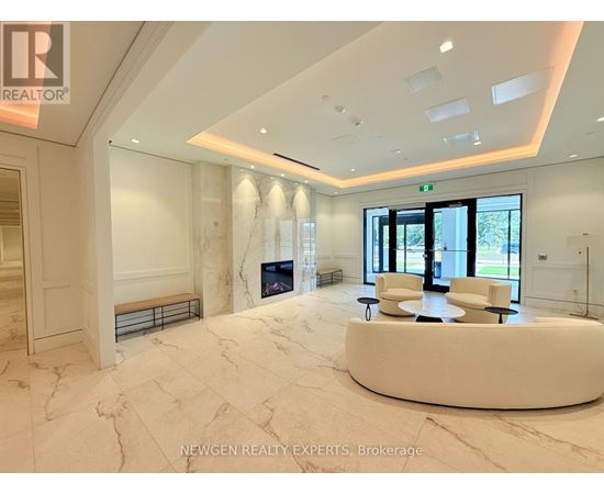 A spacious, well-lit room with a marble floor and a curved white bench.