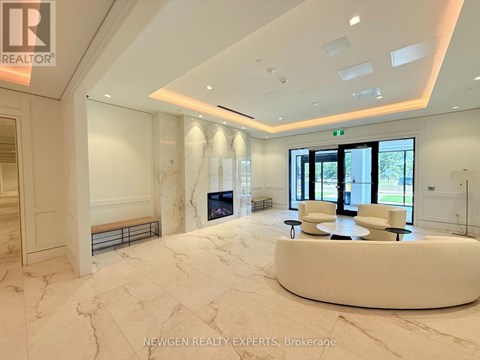 A spacious, well-lit room with a marble floor and a curved white bench.