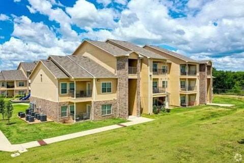 A large apartment complex with multiple buildings and green lawns.