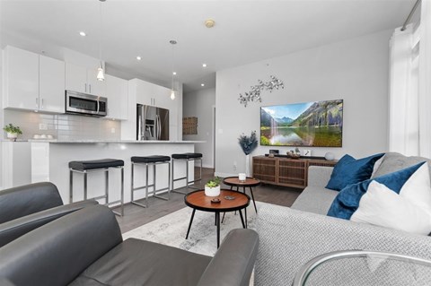 A modern living room with a grey sofa and a coffee table.