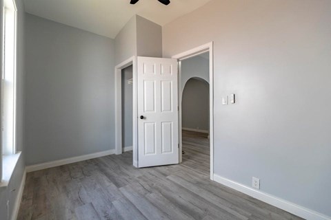 A white door is in a room with grey walls.