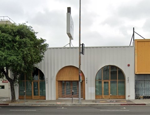 A white building with a satellite dish on top.