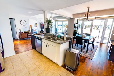A kitchen with a dining table and chairs is shown.