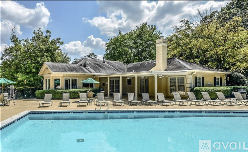 A large house with a pool in front of it.