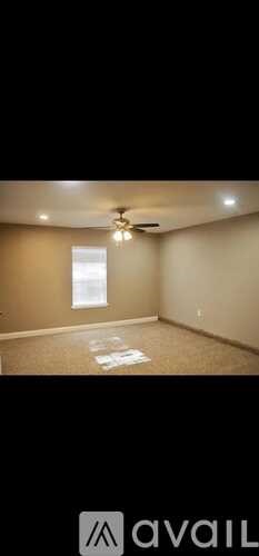 A room with a ceiling fan and a window.