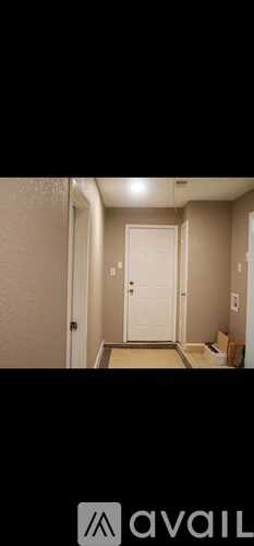 A hallway with a door at the end.