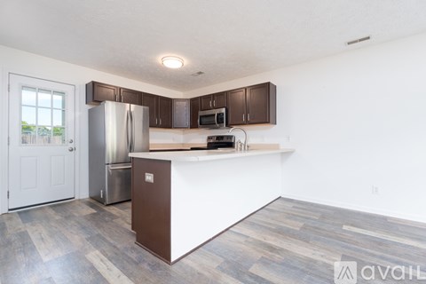 A kitchen with a white counter and brown cabinets.