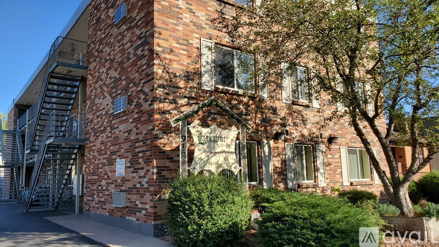 A brick building with a tree in front of it.
