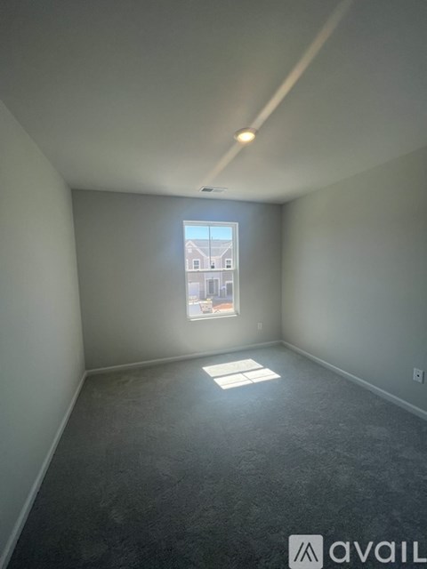 A room with a window and a view of a building outside.