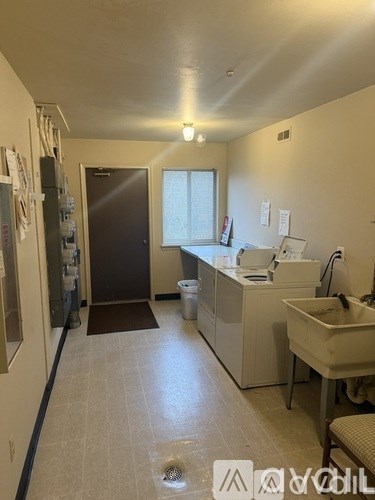 A bathroom with a sink, mirror, and toiletries.