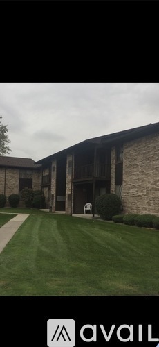 A building with a sign that says "avail" in front of it.