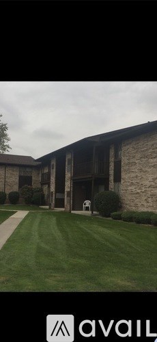 A building with a sign that says "avail" in front of it.