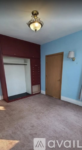A room with a brown door and a white window.