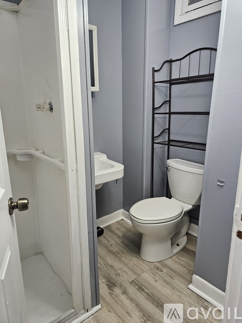 A white toilet in a bathroom with a white door.