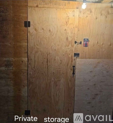 A wooden door with a lock and a sign that says "Private storage".