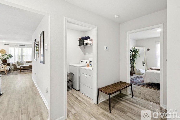 A well-lit, spacious room with a washer and dryer in the corner.