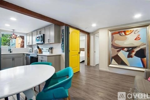 A modern kitchen with a dining table and chairs.